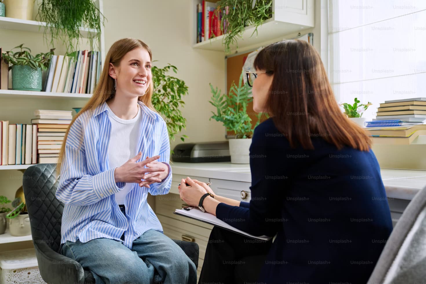 A facilitator leading a discussion with people around a table.
